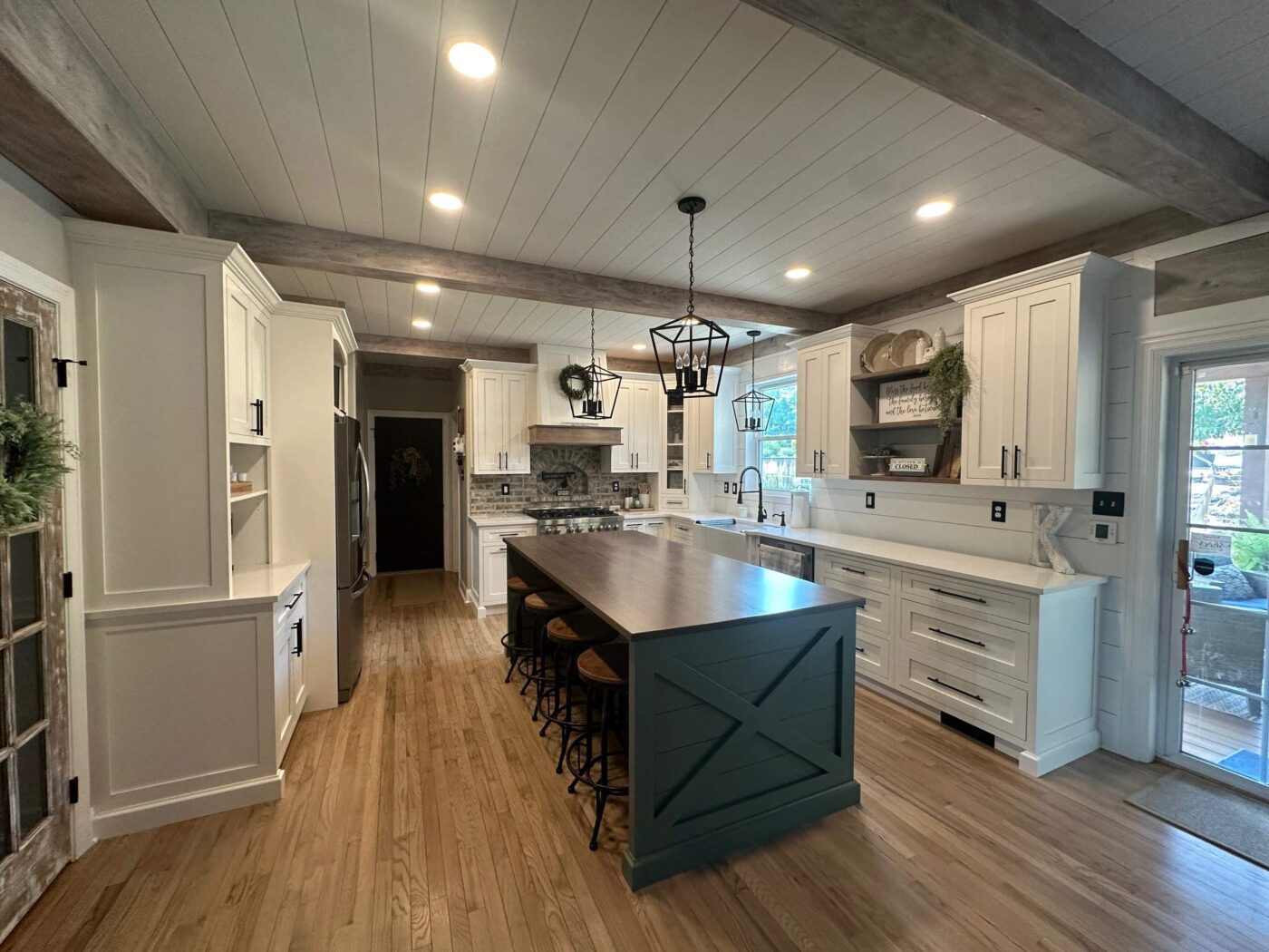 An Inviting, Cozy Looking Kitchen With Fancy Lights And Ceilings