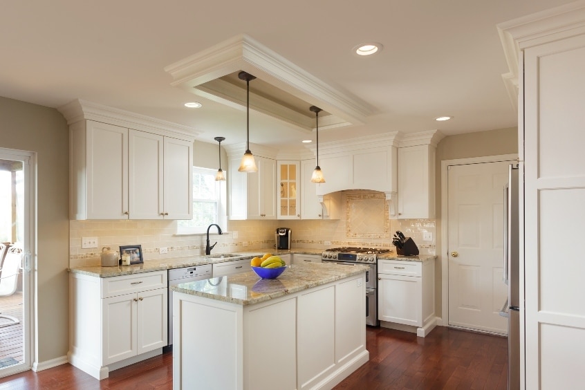 A Newly Remodeled Kitchen With A Light, Tan Theme, New Granite Countertops, And A Stylish Tan Backsplash, Completed By Home Remodeling Contractors In Ephrata Pa