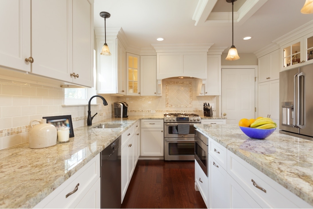 A Newly Remodeled Kitchen With A Light, Tan Theme, New Granite Countertops, And A Stylish Tan Backsplash, Completed By Home Remodeling Contractors In Gladwyne Pa