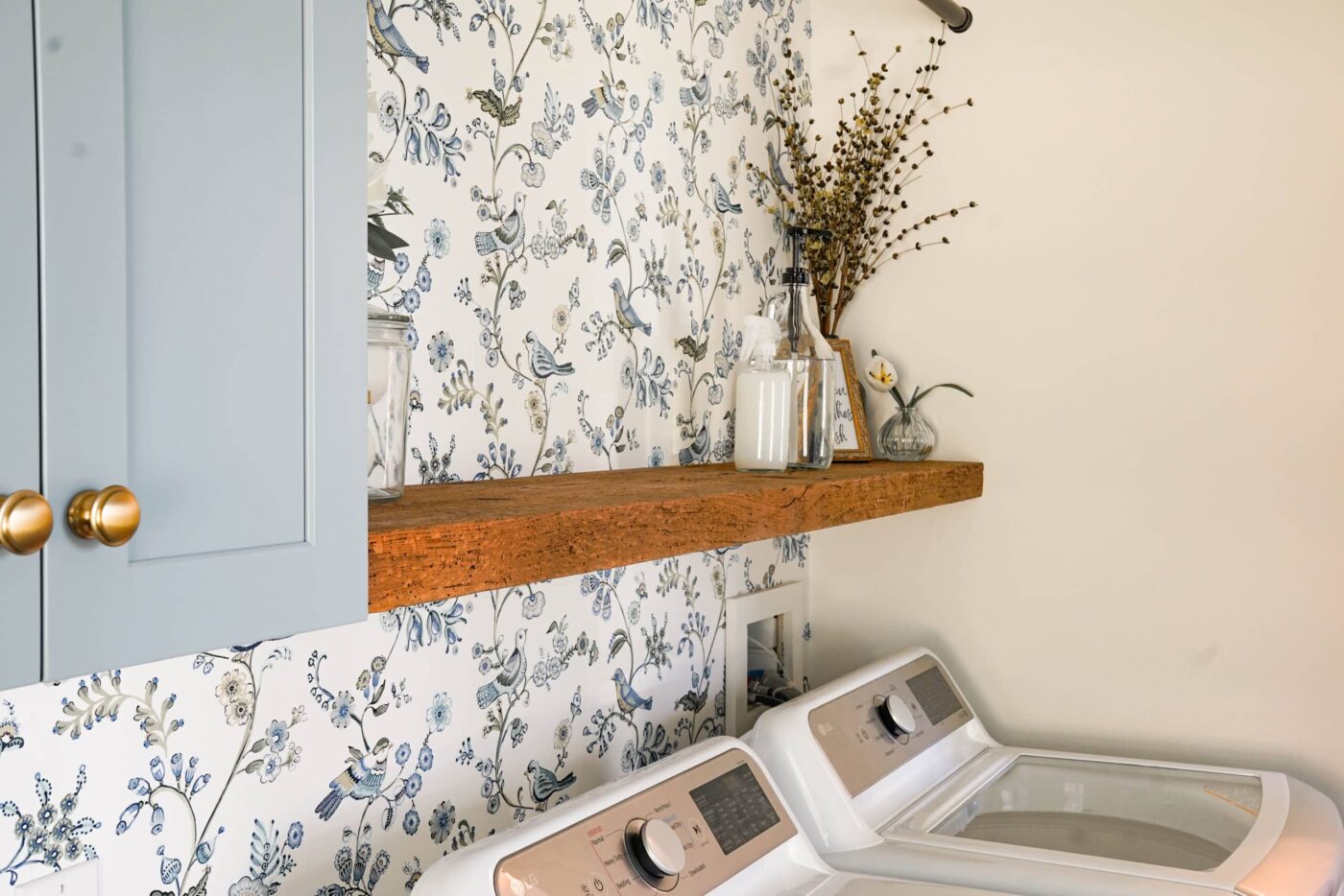 A Custom Laundry Room In Downingtown Pa With A Light-Blue Floral Pattern Wallpaper, And Light-Blue Cabinets