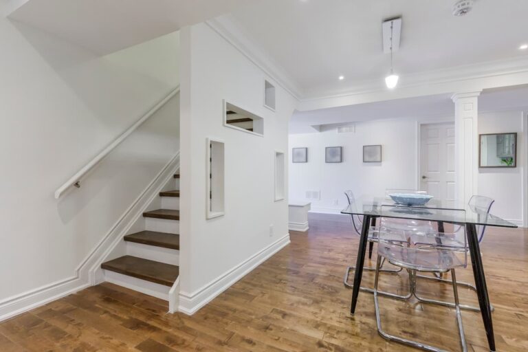 A Basement With White Trim, Added Lighting, And Hardwood Flooring That Was Remodeled And Finished By Basement Remodeling Contractors From Foggy Ridge